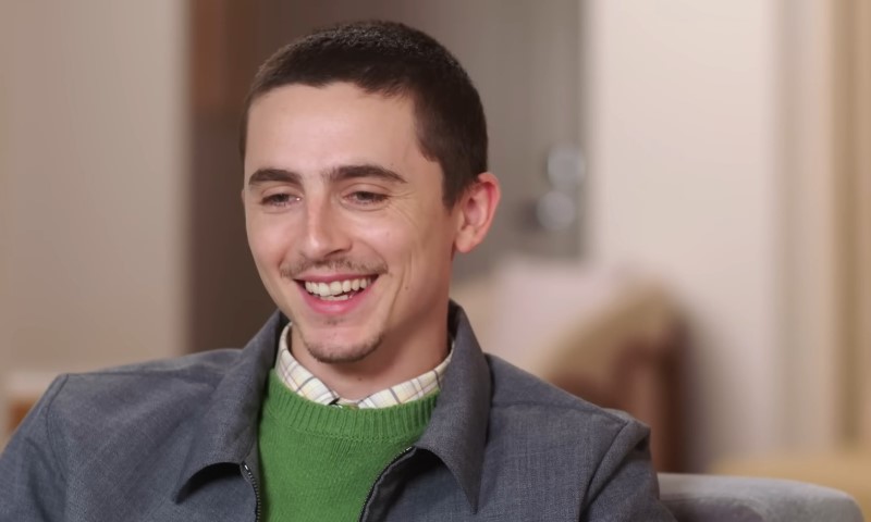 Timothée Chalamet smiles while in podcast