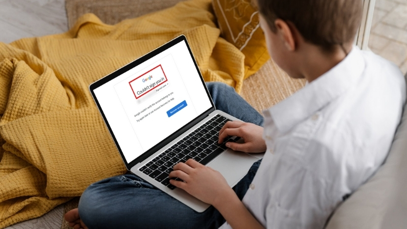 Person using a laptop showing a Google account recovery error message screen
