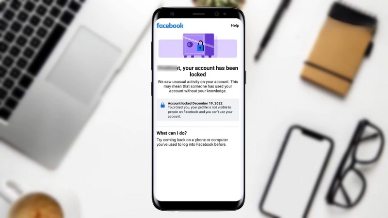 Phone screen showing Facebook notification that the account has been locked due to unusual activity