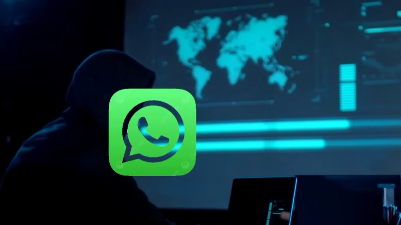 Person using a laptop with a hooded silhouette and WhatsApp logo, illustrating a WhatsApp account takeover scenario