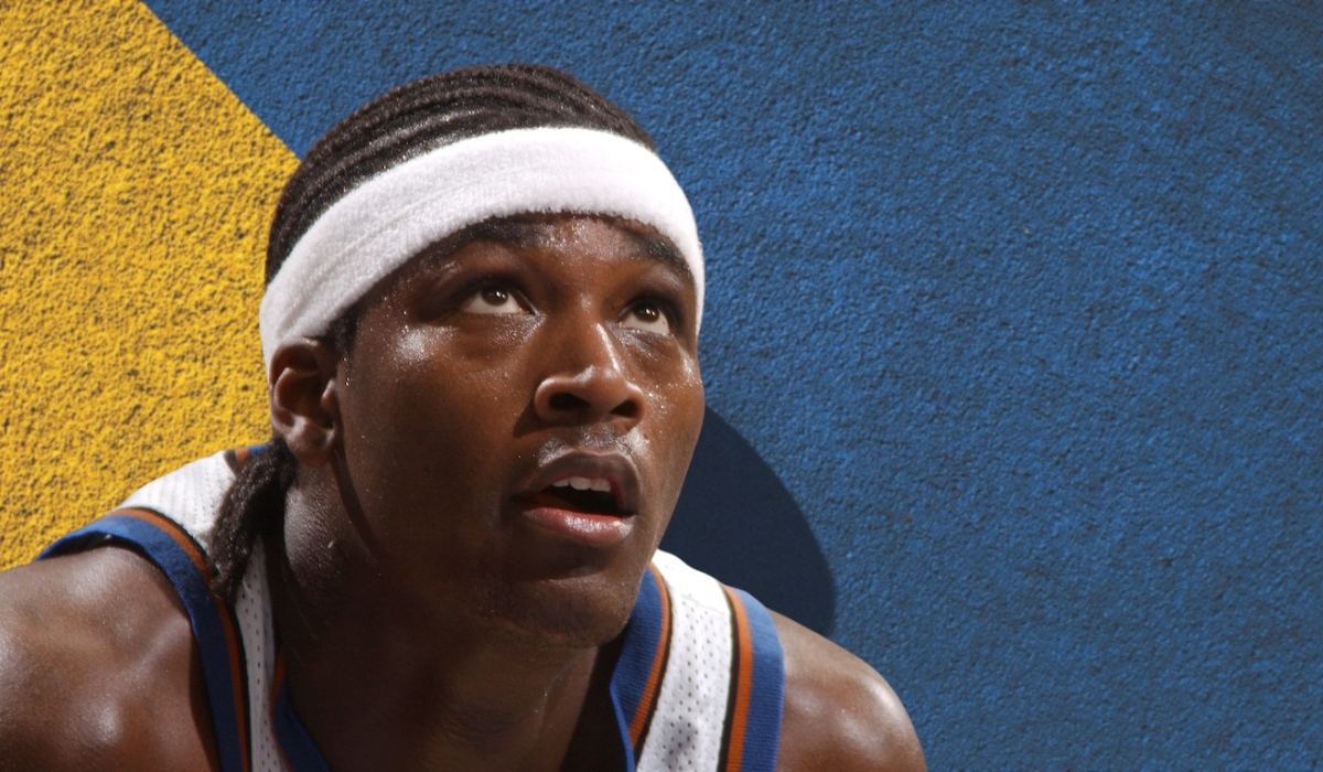 Close up of basketball player Kwame Brown wearing a headband and jersey during an NBA game