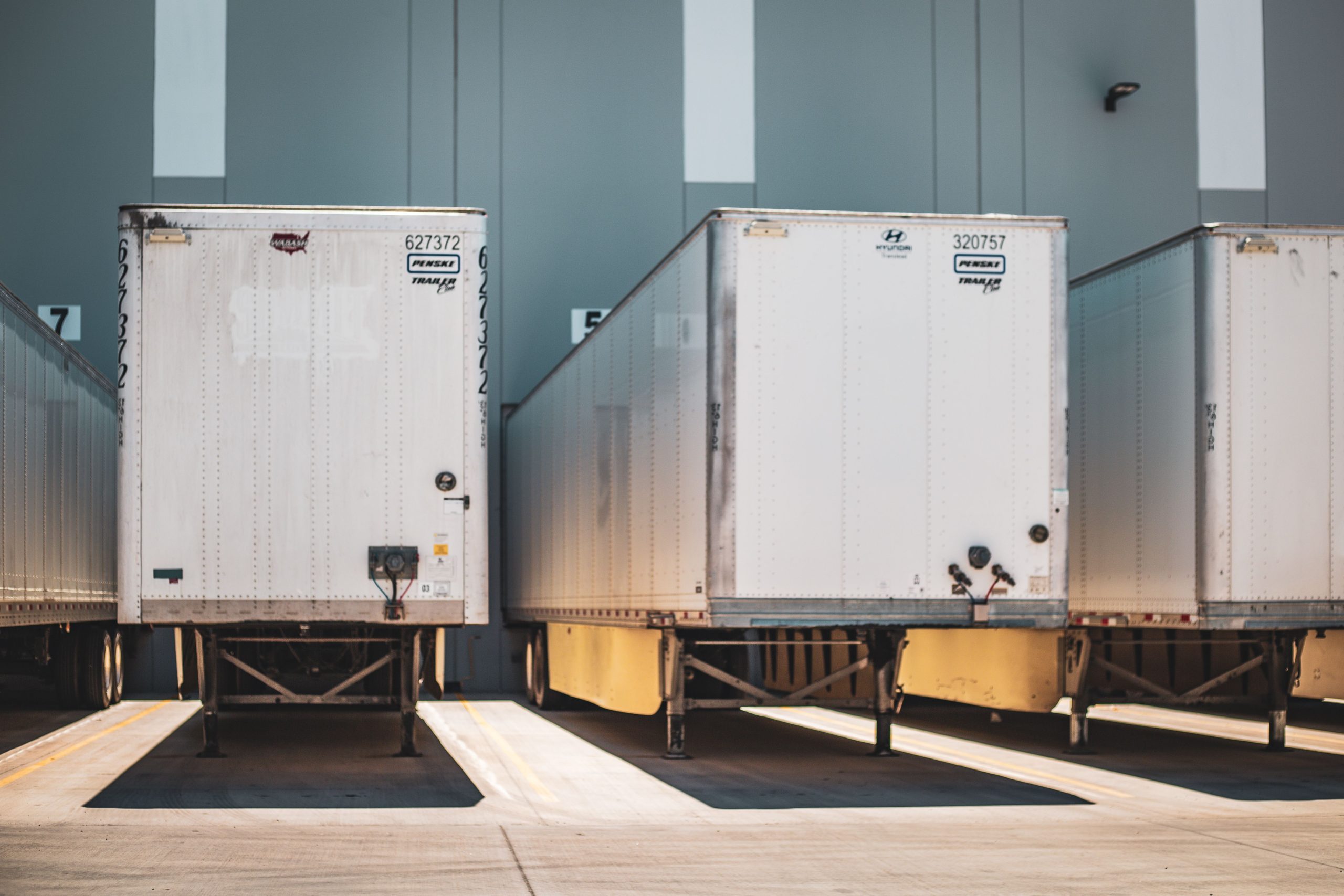 Row of freight trailers parked at a commercial loading dock representing B2B shipping logistics