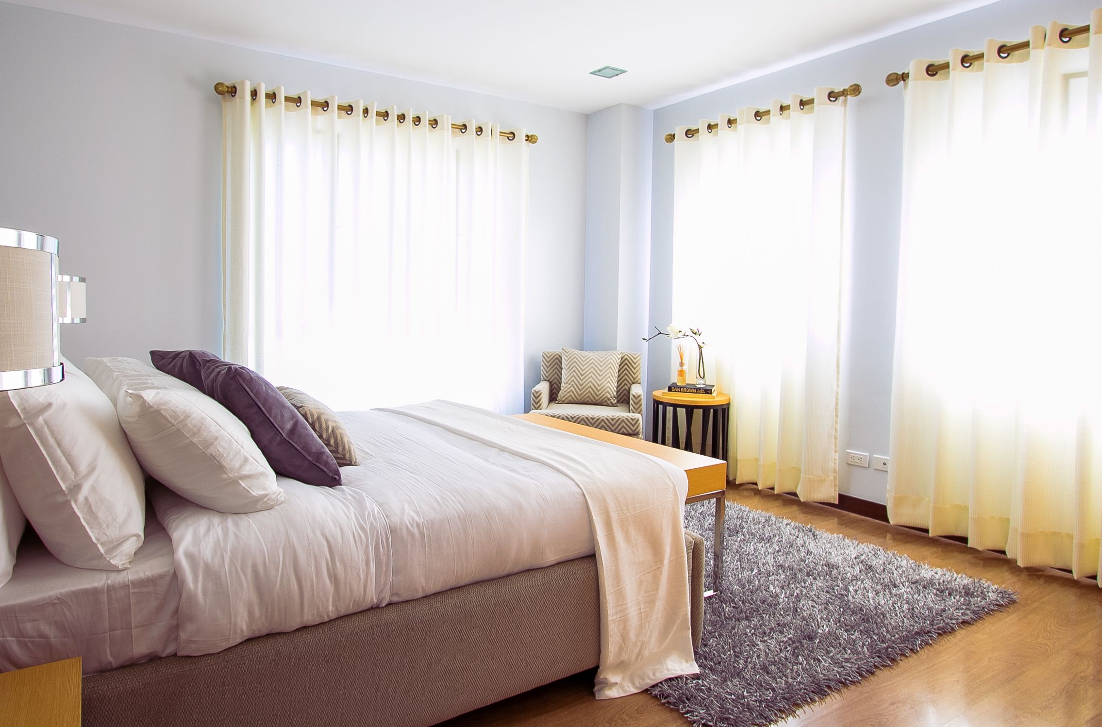 Bright, cozy bedroom with soft furnishings and natural sunlight