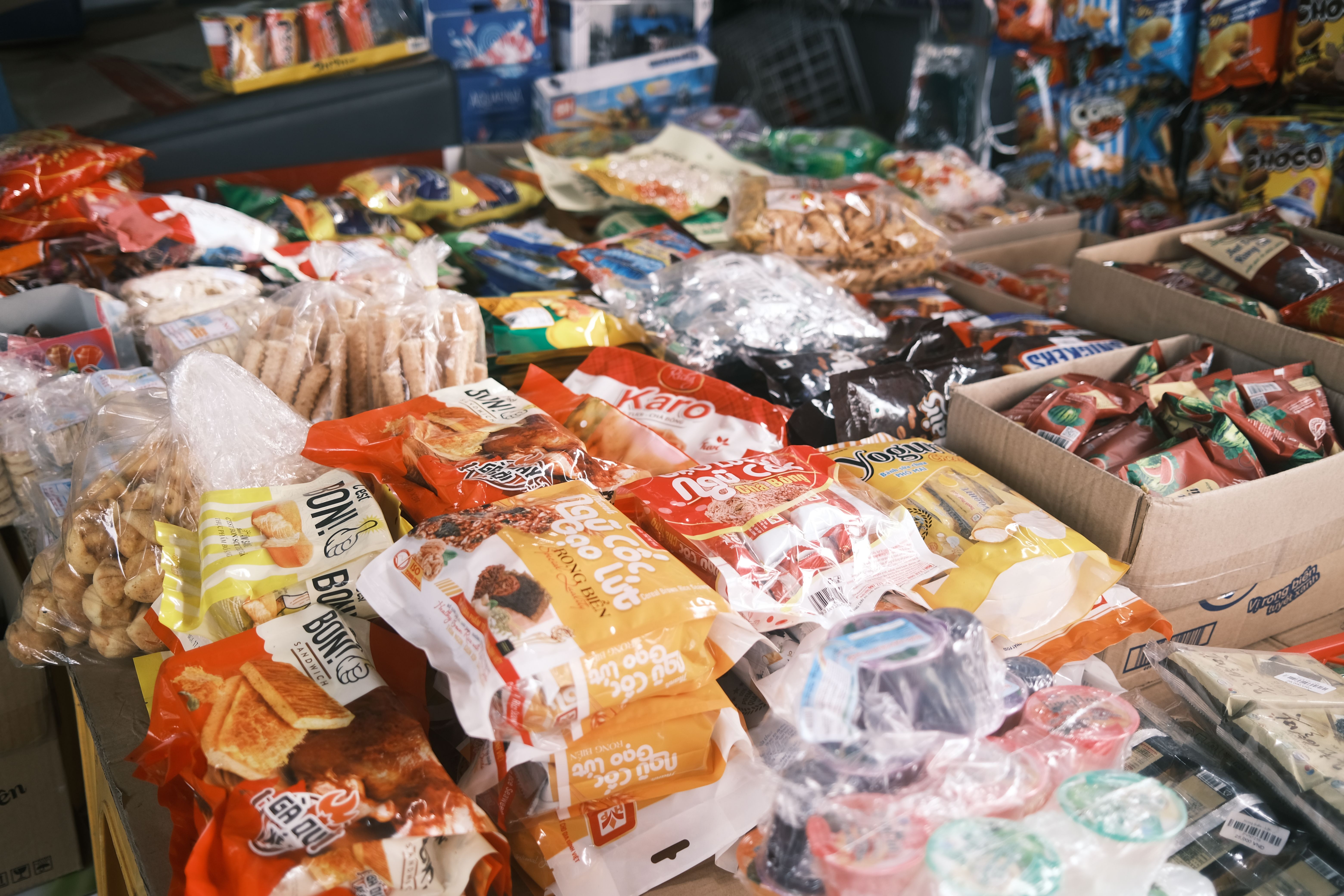Assorted packaged snacks and candies displayed near a checkout counter to encourage impulse purchases