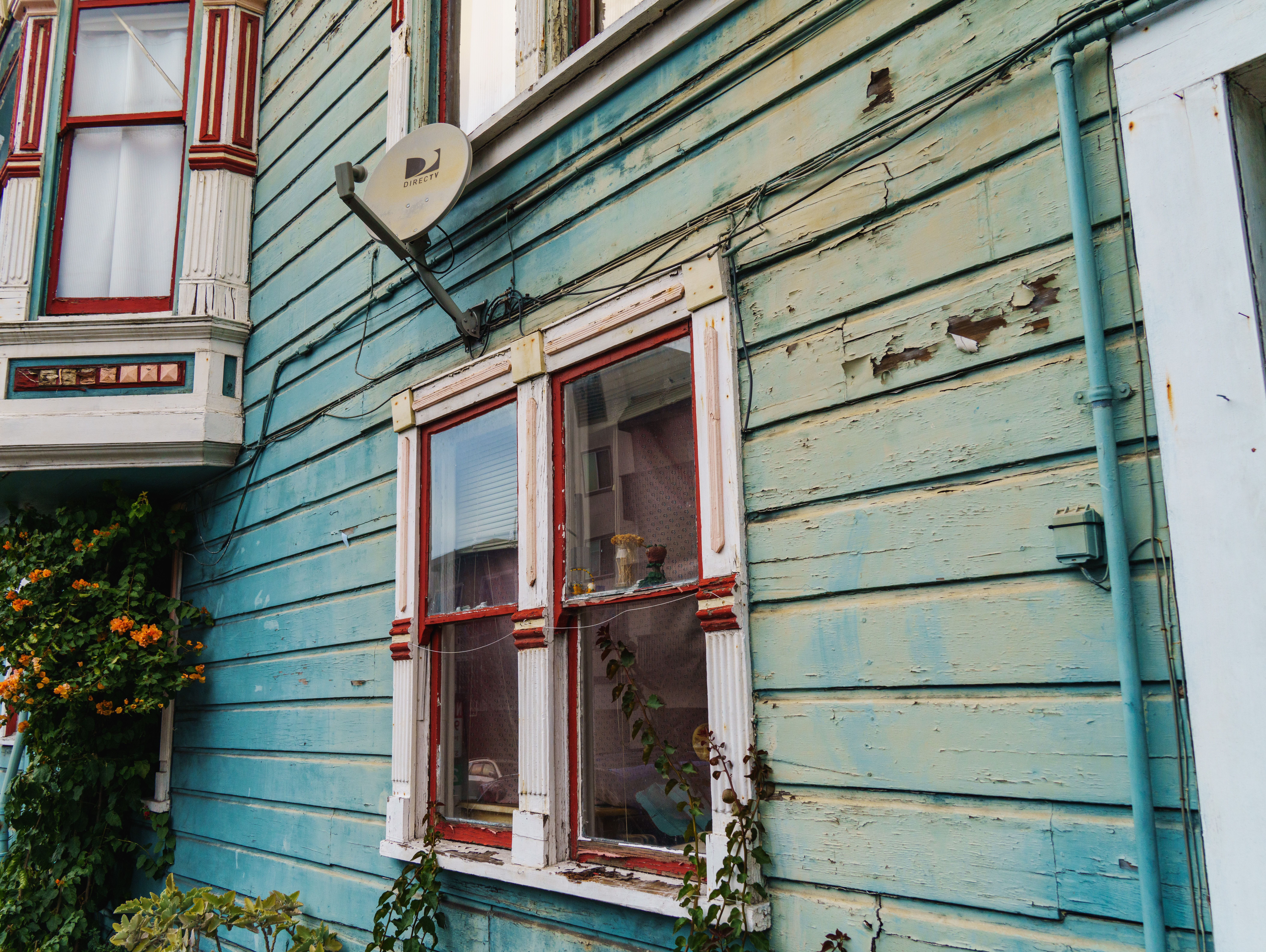 Rustic wooden house exterior with aged and faded paint