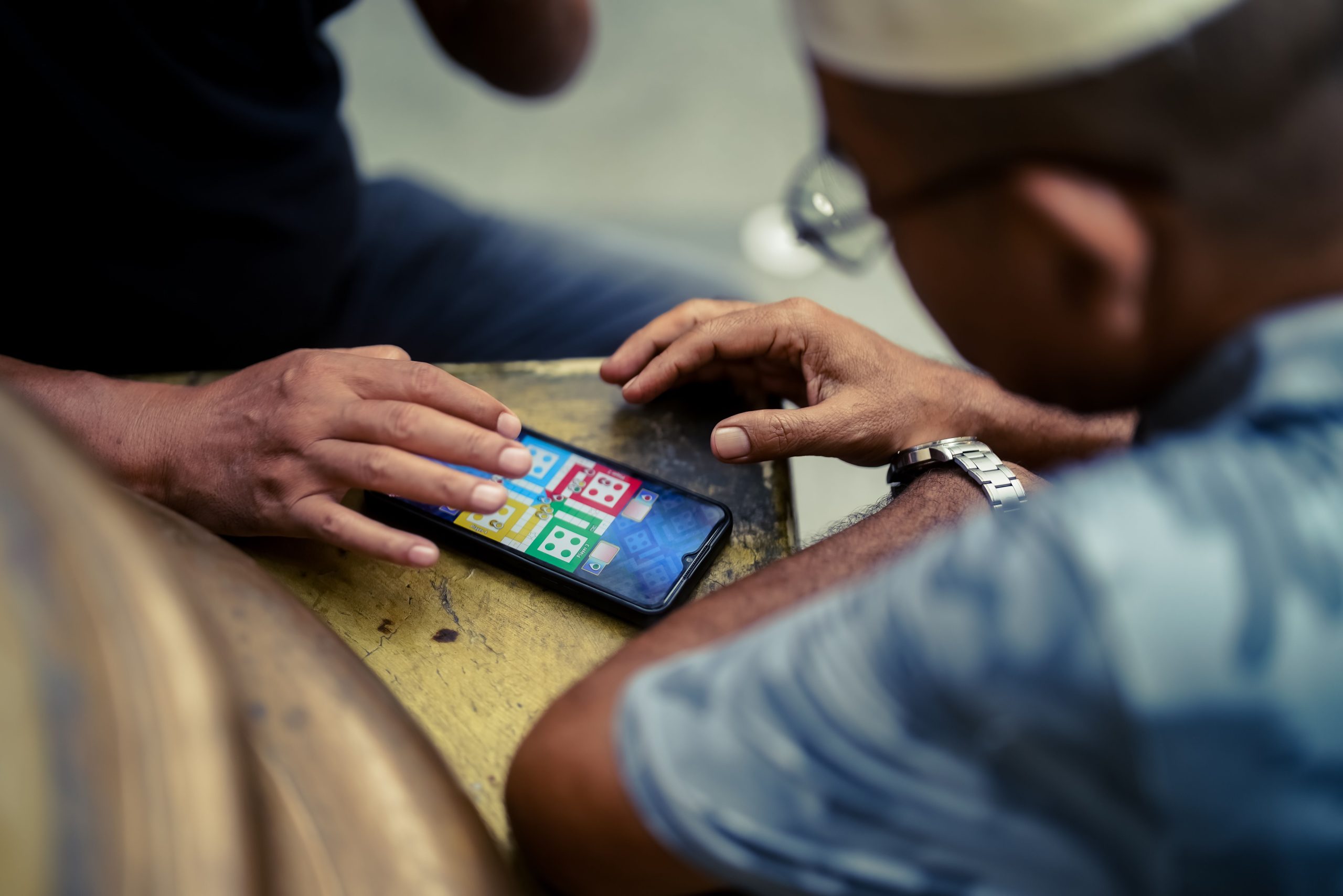 Two people playing a quick mobile game together outdoors
