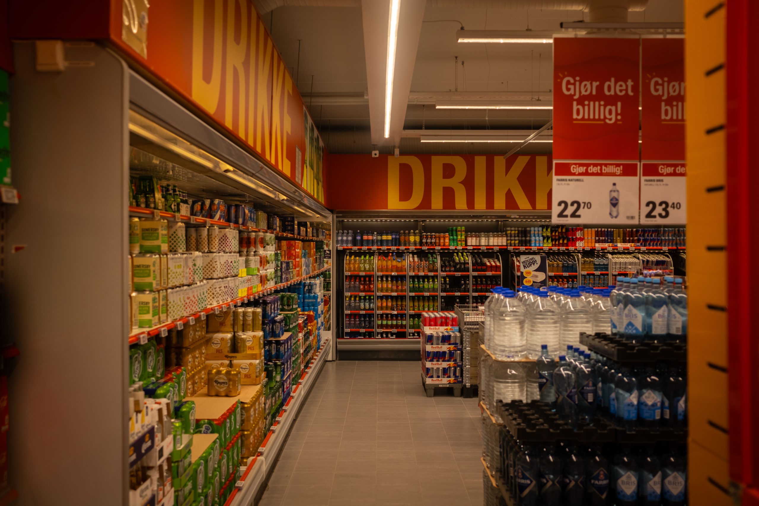 Colorful supermarket drink aisle with bold product packaging and promotional shelf signage