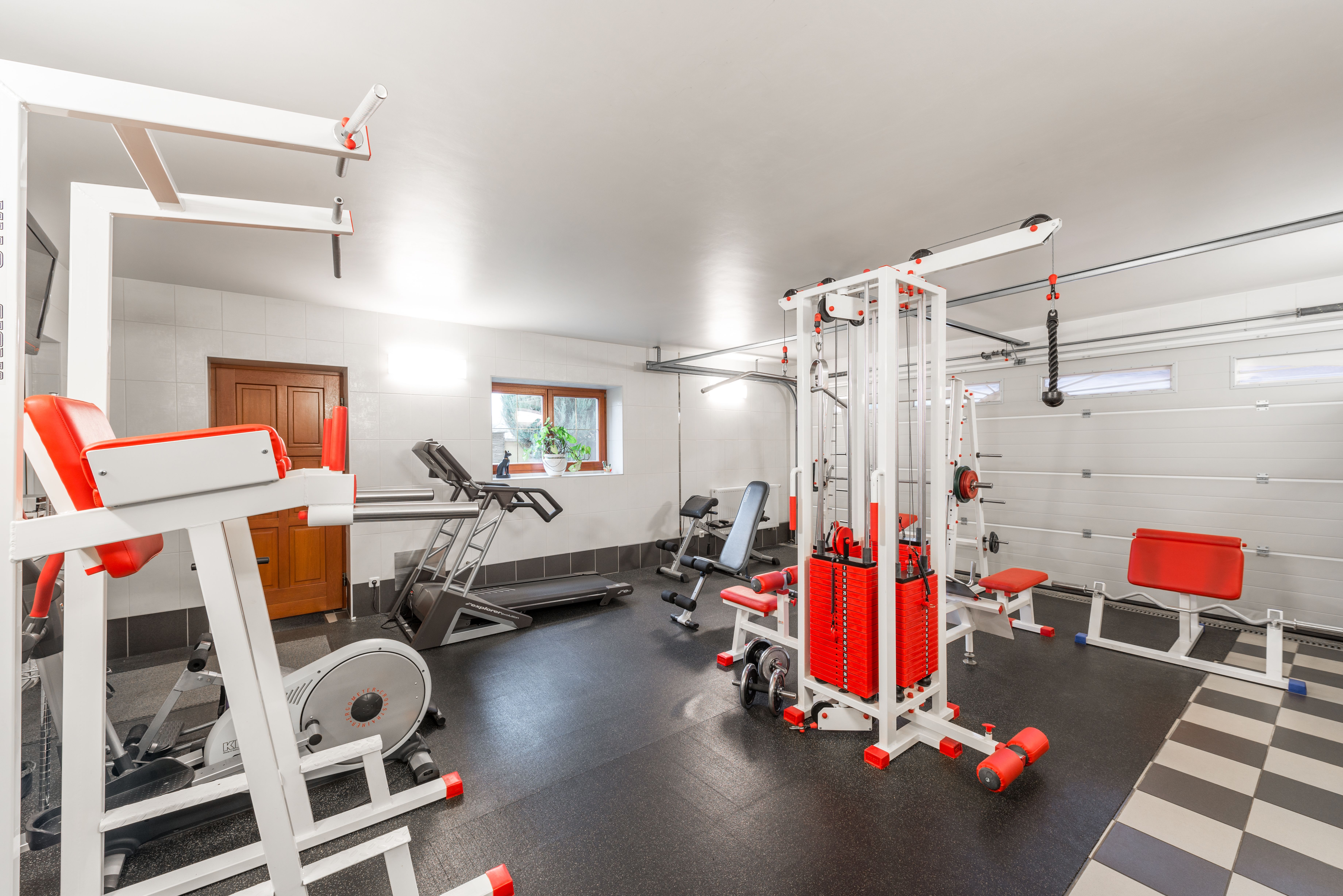 Modern spacious home gym with weightlifting equipment in a garage of a house