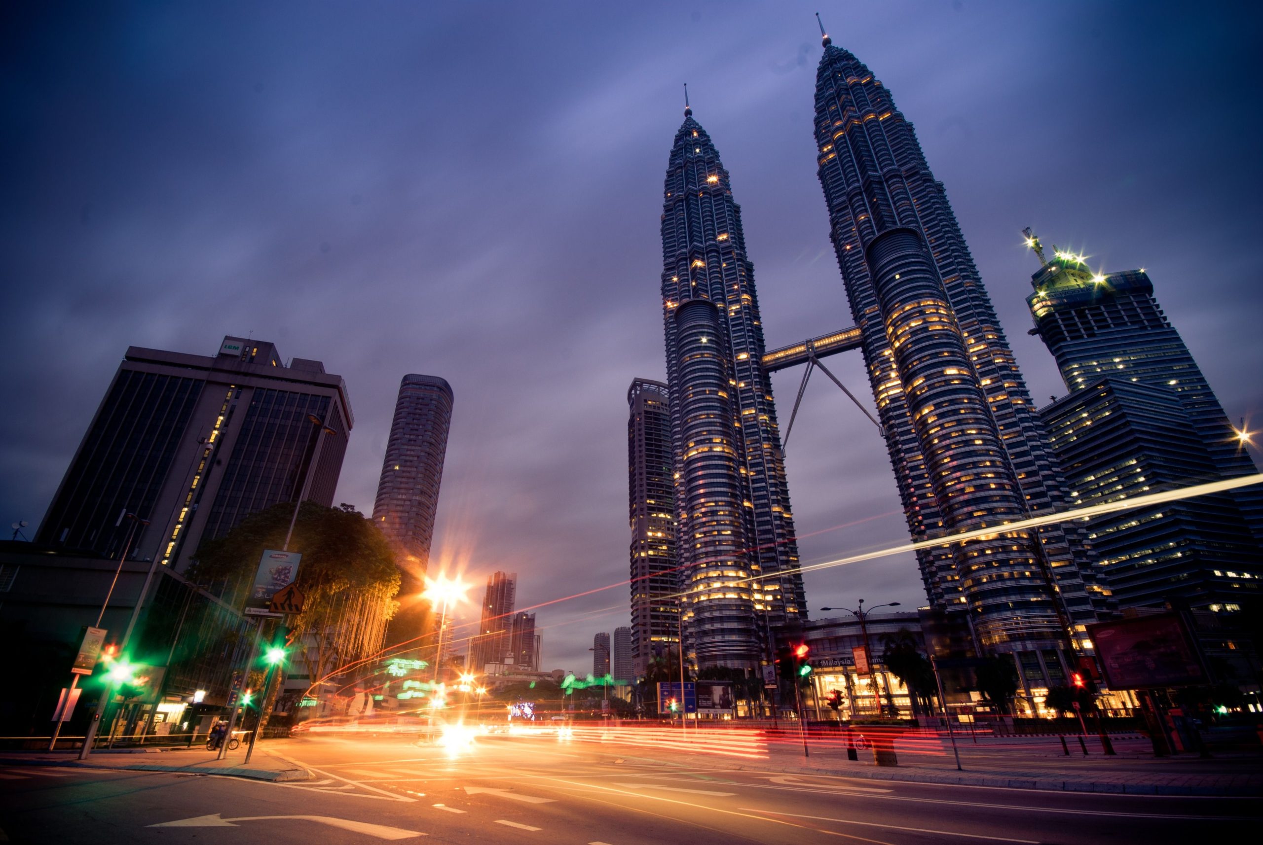 Petronas Twin Towers illuminated above Kuala Lumpur at night, a landmark stop on a first trip to Malaysia.